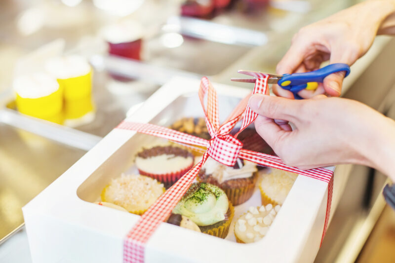 Hand packing many kinds of cupcakes a